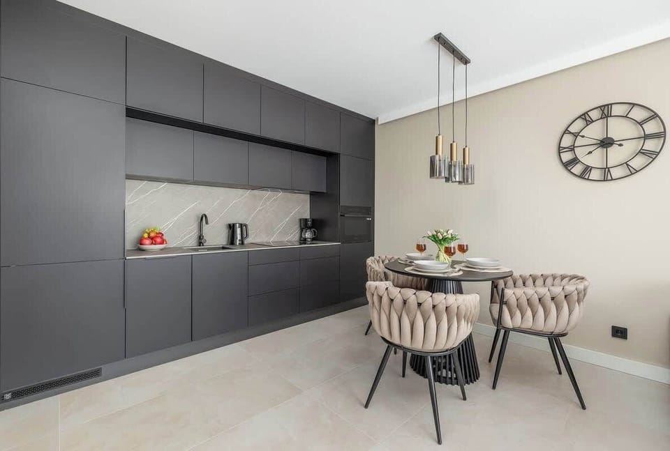The sleek design of the kitchenette blending seamlessly with the living area.