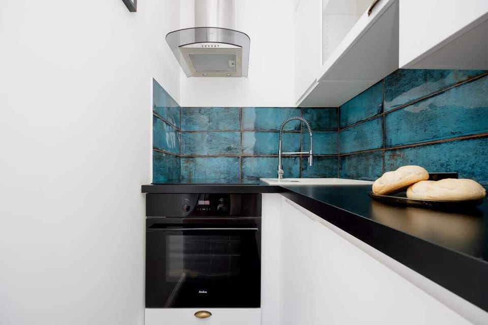 The sleek design of the kitchenette blending seamlessly with the living area.