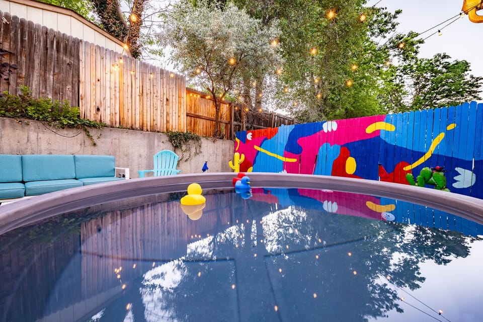 Dive into the ultimate backyard retreat! Our Cowboy Pool, surrounded by artful murals and twinkling lights, offers the perfect spot for relaxation and a splash of fun. The stock tank pool is 3ft deep - it fits 2-4 people.