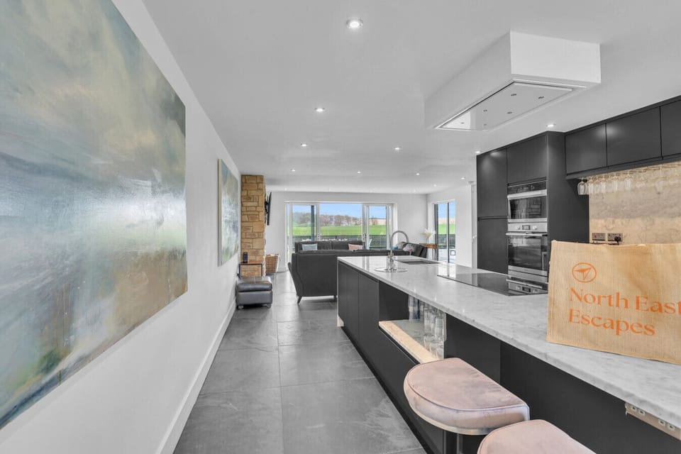 Contemporary kitchen with marble island and open-plan layout