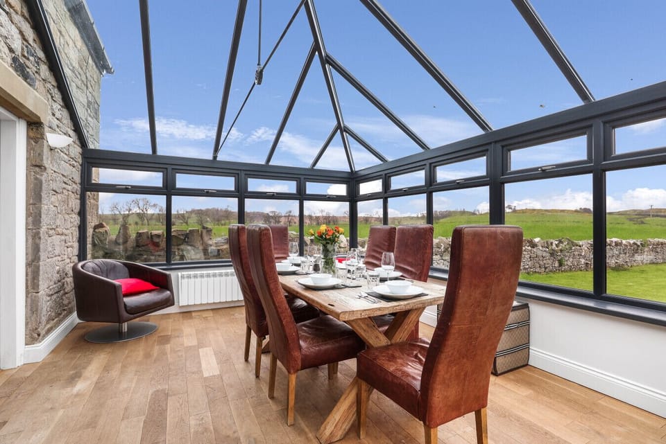 Conservatory dining room with panoramic countryside and garden views