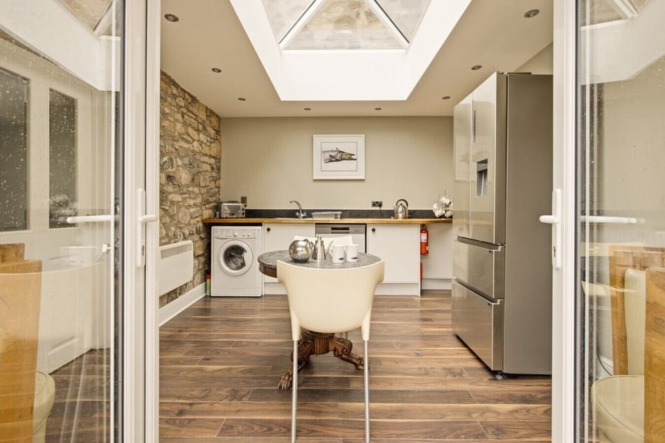 Orangery with bi-fold doors opening onto the courtyard
