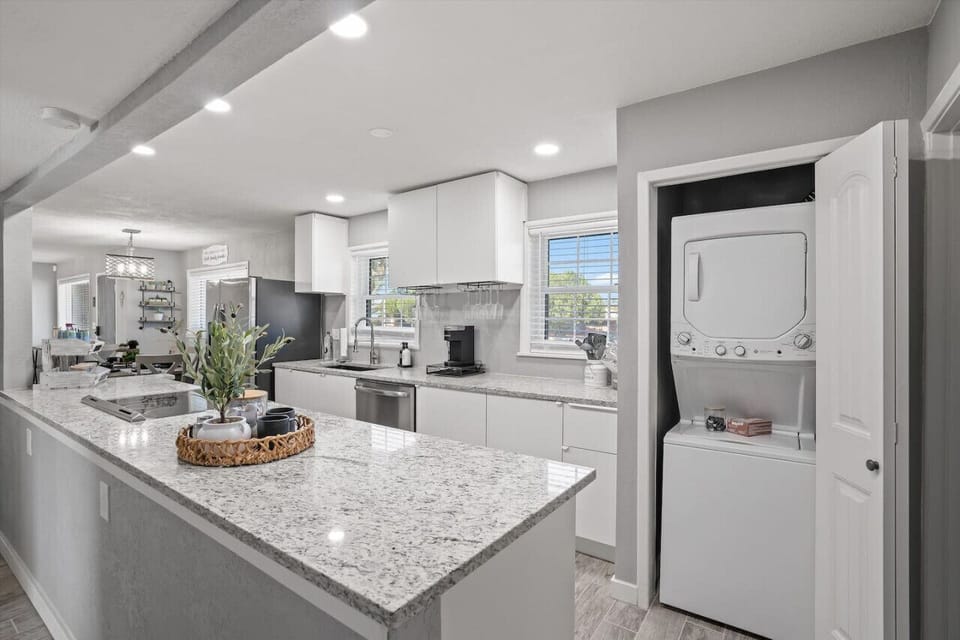 Modern kitchen w/ stainless appliances, clean counters & room to prep meals together.