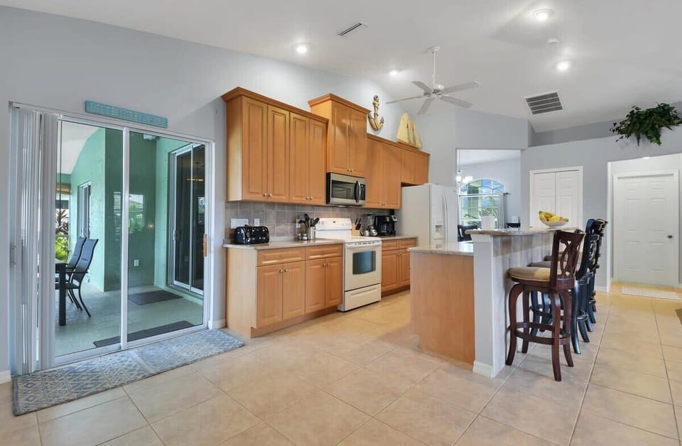Everything you need in this kitchen that leads out into the pool lanai dining area.