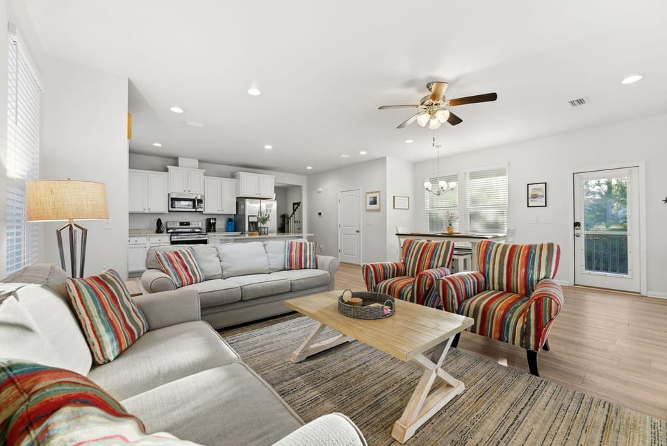 Relax in your bright open living space with colorful striped accents and modern kitchen—perfect for unwinding after exploring.