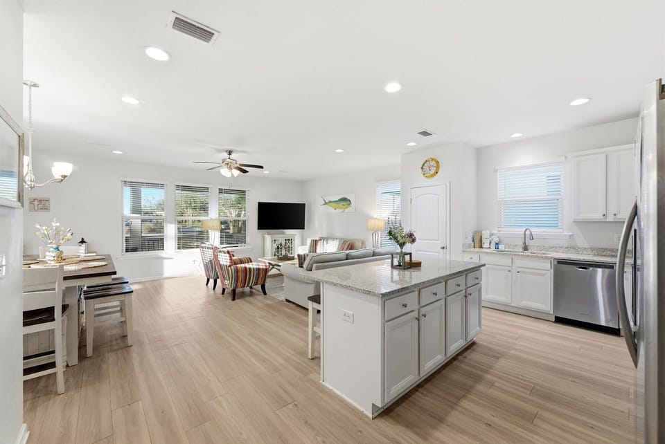 Your open-concept kitchen flows seamlessly into the living area, featuring granite countertops and stainless steel appliances for effortless meal prep.