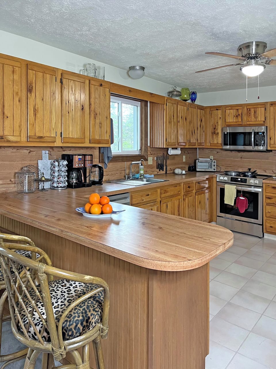 Spacious kitchen with island seating, coffee bar, and modern appliances.