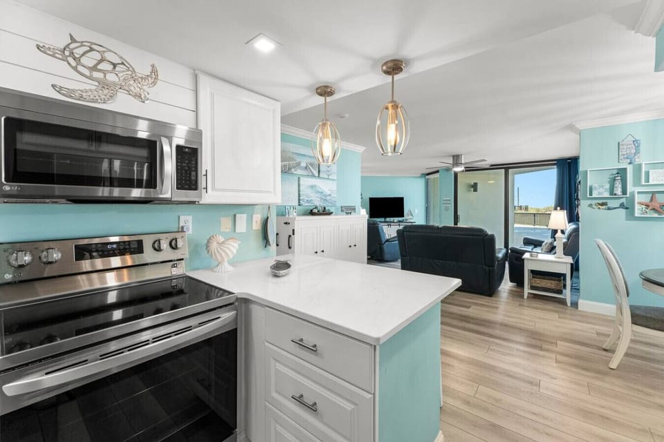 Fully Stocked Kitchen with Ocean Views, Stainless Steel Appliances and Island Bar Seating