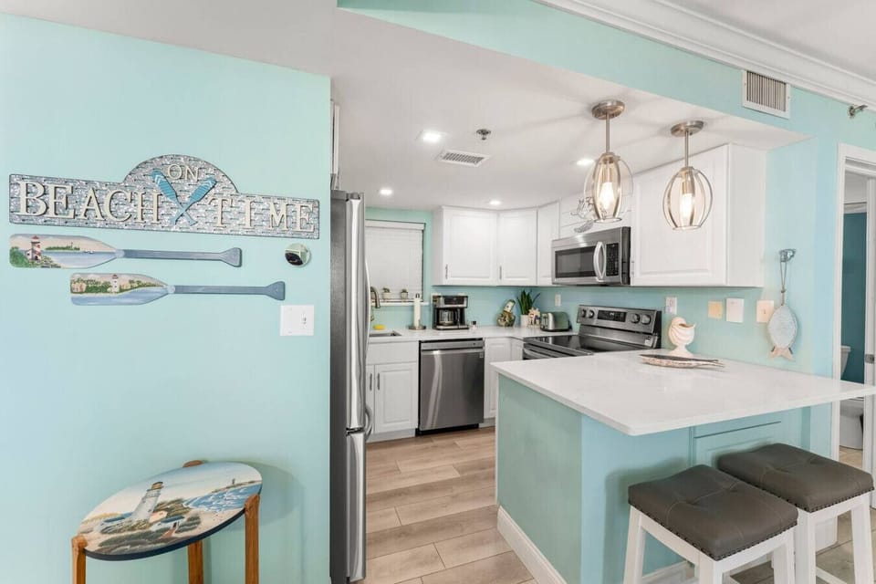 Fully Stocked Kitchen with Ocean Views, Stainless Steel Appliances and Island Bar Seating