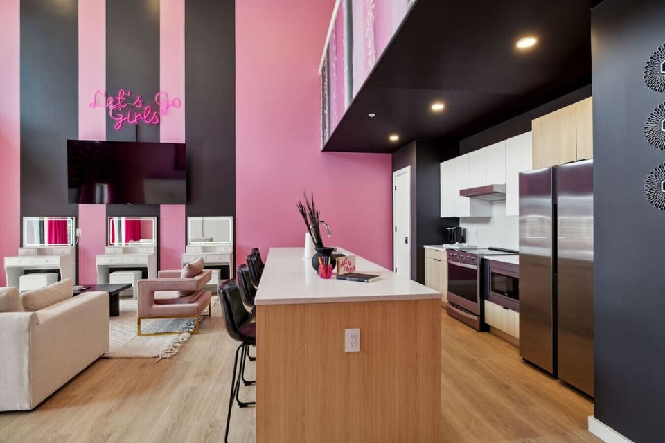 Sleek open-concept kitchen flowing into the living room with spacious counters and bar seating—perfect for coffee, cocktails, and gathering
