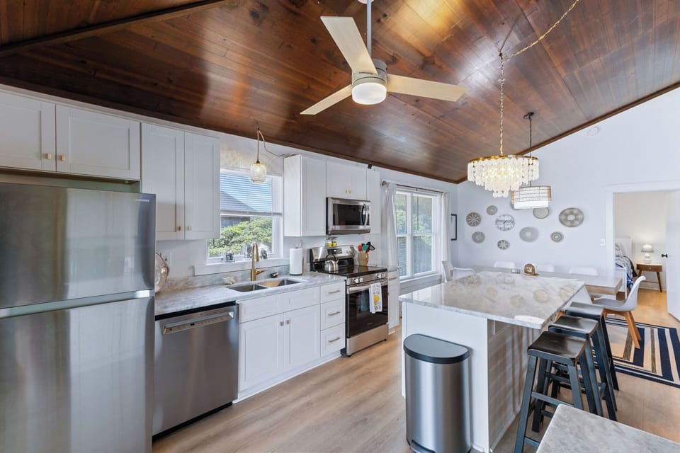 Kitchen - This kitchen is to die for with elegant lighting, stainless appliances, and an ocean view.