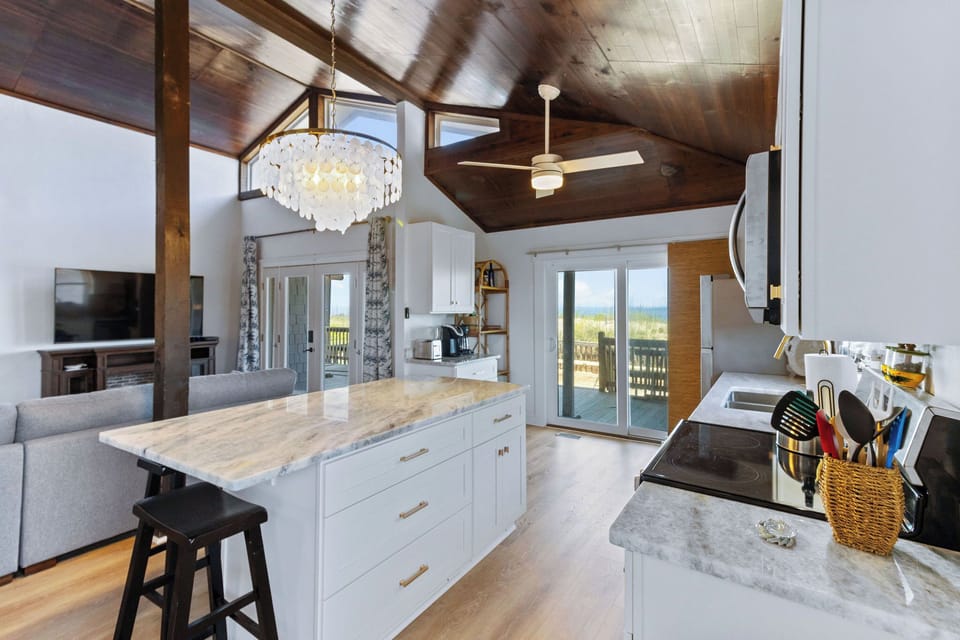 Kitchen - This kitchen is to die for with elegant lighting, stainless appliances, and an ocean view.