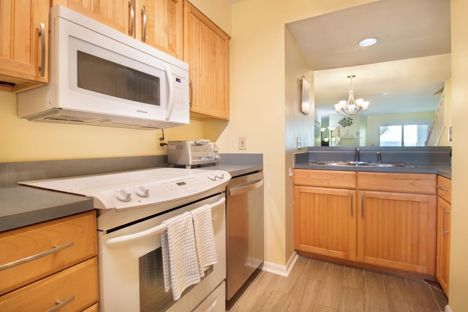 Cook your favorite meals in this fully-equipped kitchen with modern appliances and sleek granite countertops.