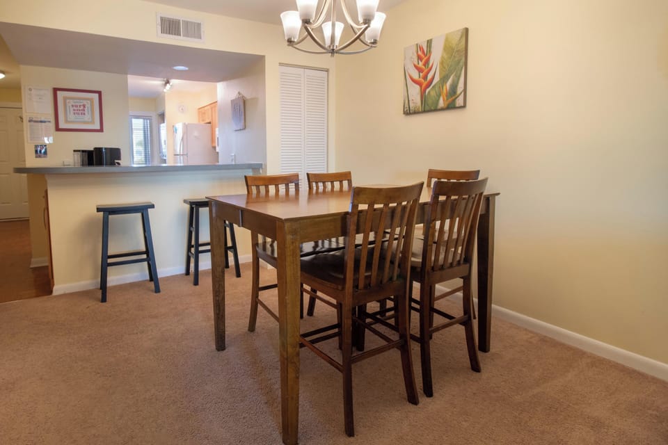 Gather your group around this spacious dining table for memorable meals, with the open kitchen nearby for easy entertaining.