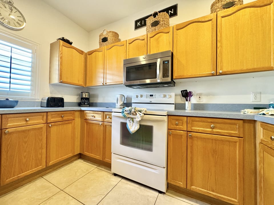 Spacious kitchen with stainless steel appliances and ample counter space.