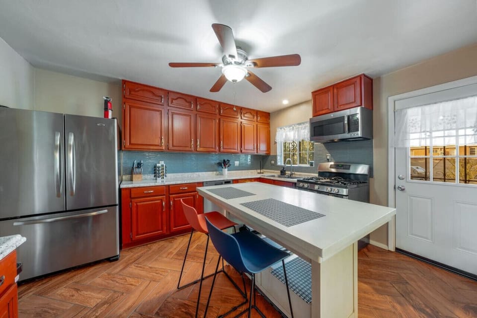 Updated kitchen with stainless steel appliances, island, and plenty of storage and counter space