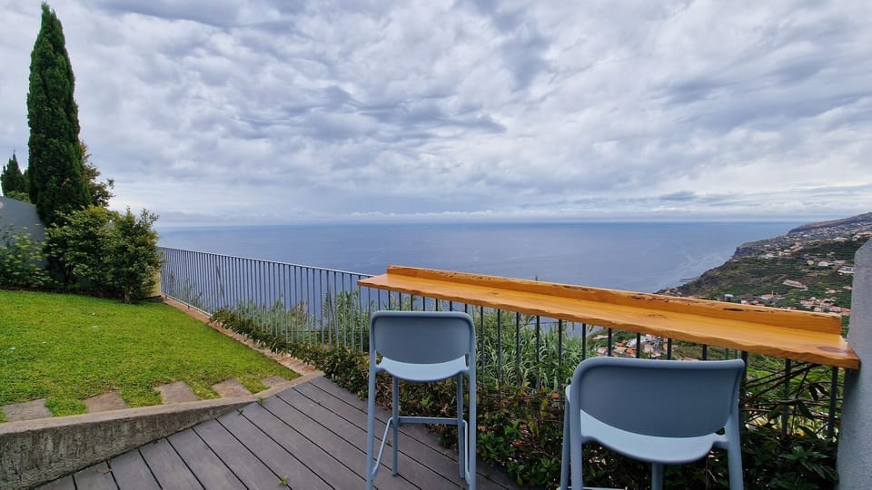 Relax in the elegant seating area at The Red Hot Chill House, overlooking breathtaking ocean and mountain views. Perfect for sipping your morning coffee or enjoying a serene sunset. #oceanview #garden #mountainview