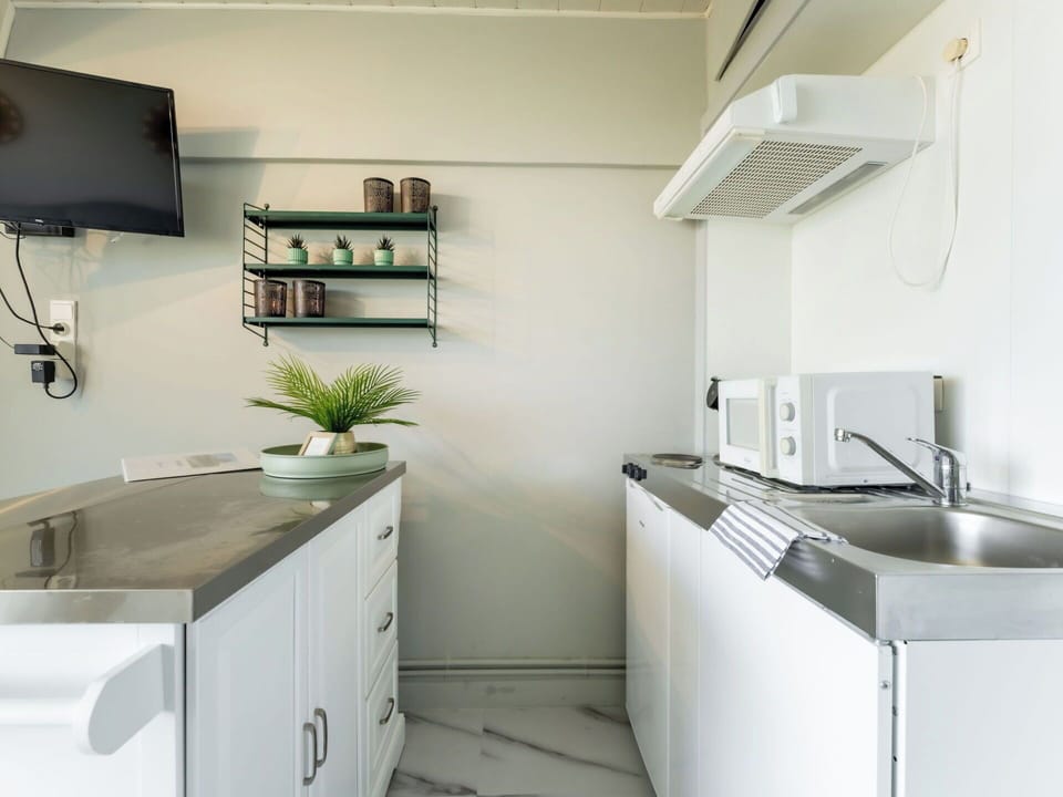 Furniture, Interior Design, Kitchen, Kitchen Appliance, Flooring, Countertop, Major Appliance, Cabinetry, Floor, Home Appliance