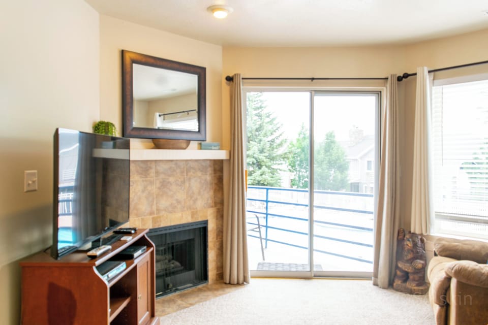 View of living area - sliding door to patio, gas fireplace, flat screen TV,