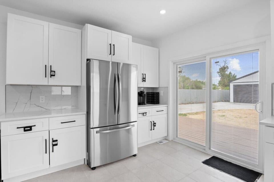 Fully Equipped Kitchen | Cooking Basics Includes stainless steel appliances and backyard access.