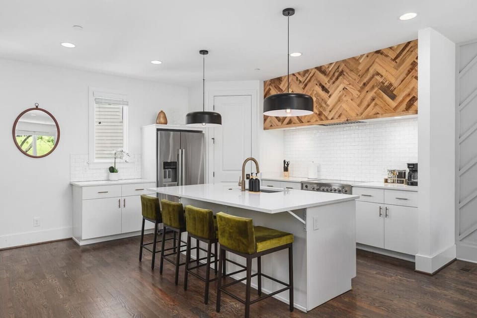 High-end appliances, large pantry, and all the cooking supplies you might need in this bright & fresh kitchen with seating for four at the island.