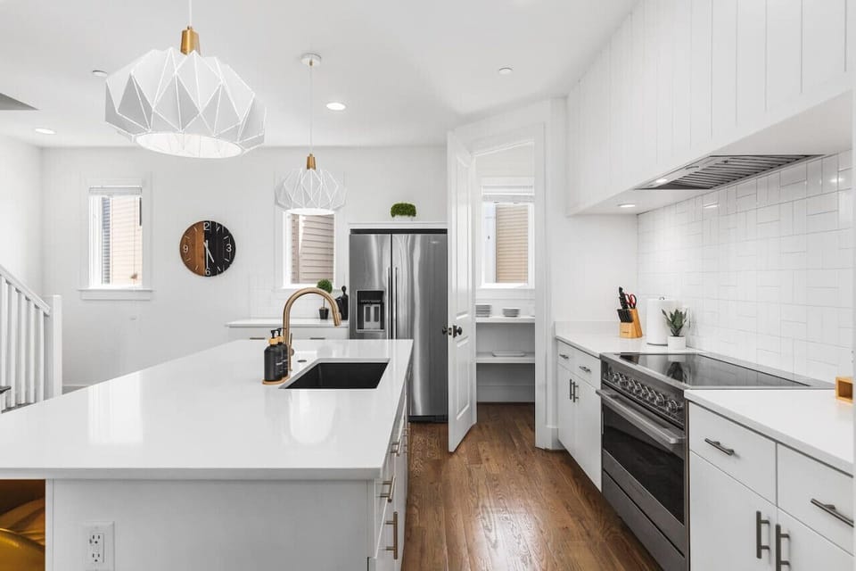 Bright and fresh kitchen with a large pantry & all the supplies you might need to share a great meal.