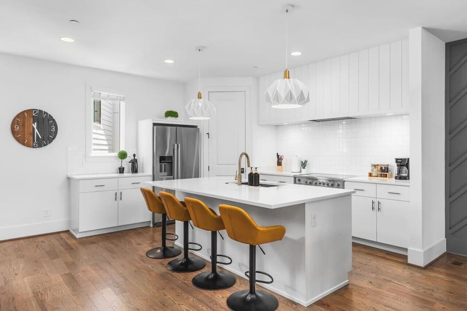 High-end appliances, large pantry, and all the cooking supplies you might need in this bright & refreshing kitchen with seating for four at the island.