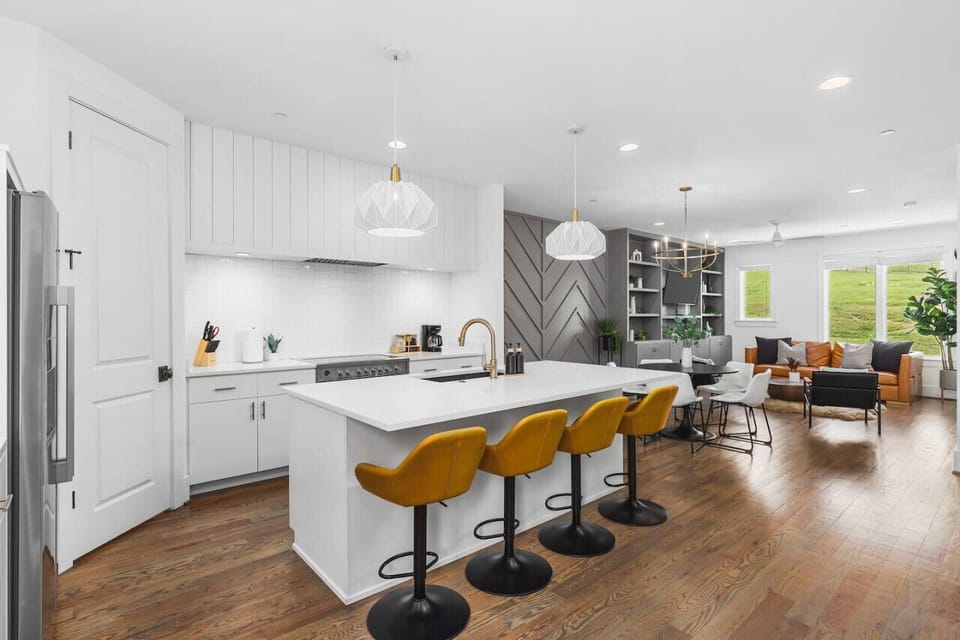 High-end appliances, large pantry, and all the cooking supplies you might need in this bright & refreshing kitchen with seating for four at the island.