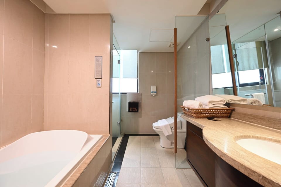 Deluxe Quadruple Room | Bathroom | Separate tub and shower, rainfall showerhead, hair dryer, slippers