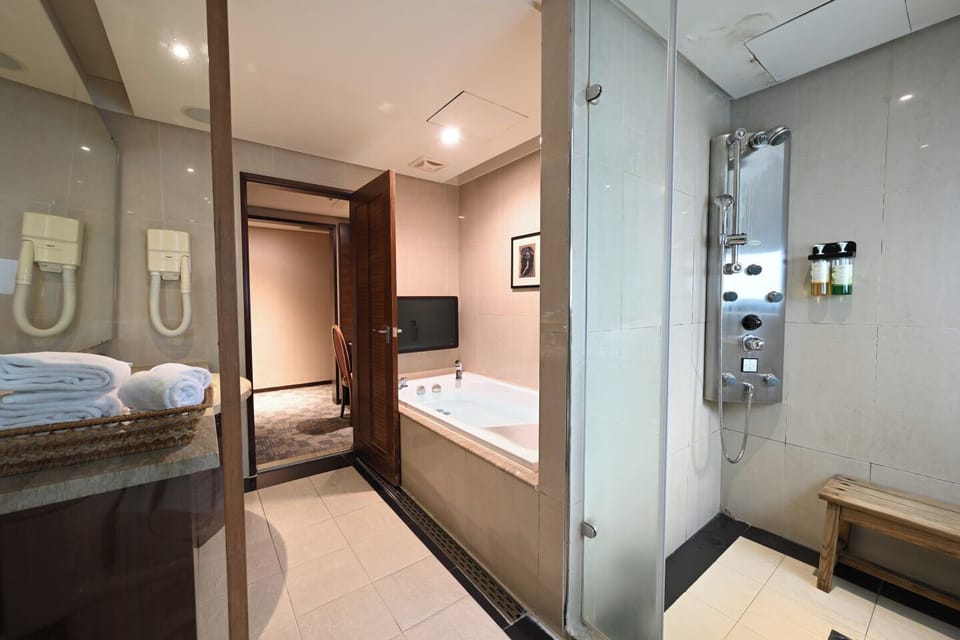 Separate tub and shower, rainfall showerhead, hair dryer, slippers