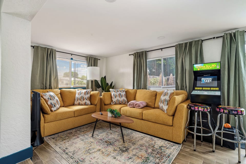 The living room features an arcade game, bringing entertainment and a playful touch. Queen Sofa bed that can sleep 2 if needed!