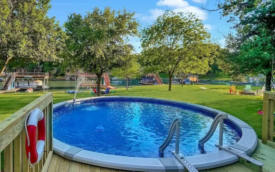 Private pool overlooks the large backyard and lake.