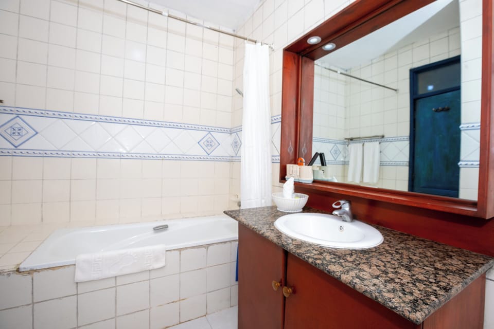 Executive Suite, Balcony, Beach View | Bathroom | Combined shower/tub, slippers, towels, soap