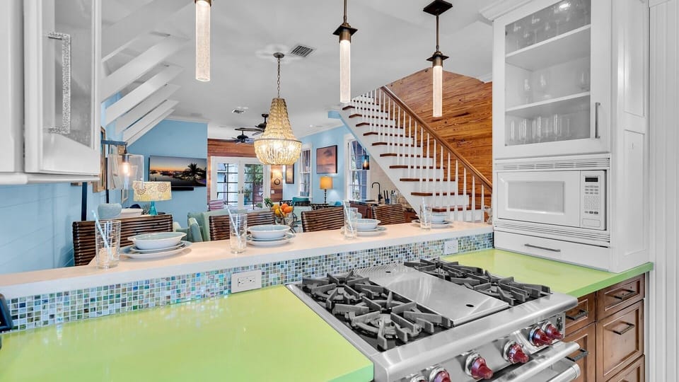 The kitchen features stainless steel appliances, including a propane range...
