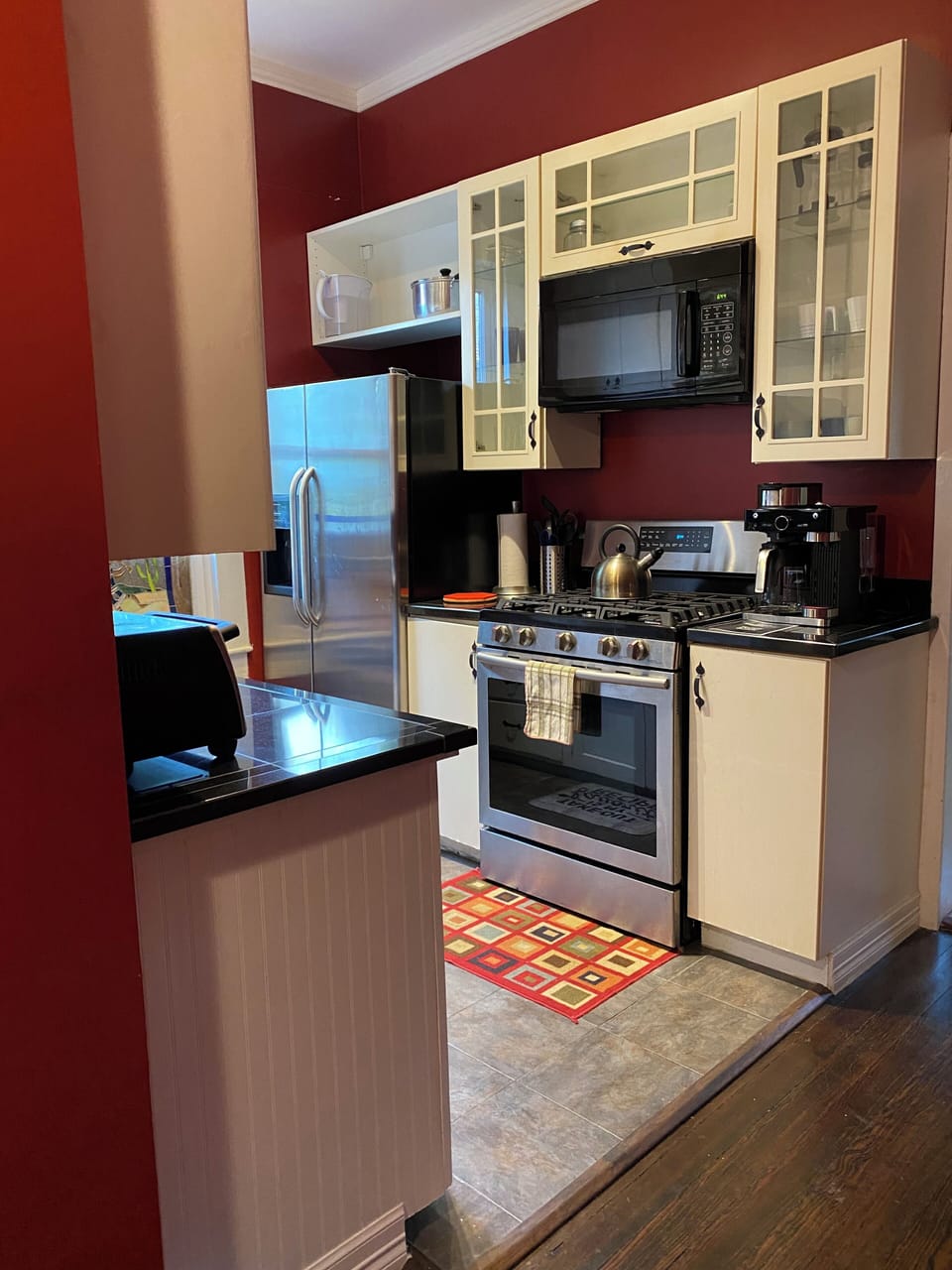 Kitchen showing the refrigerator, gas range, microwave, and coffee maker