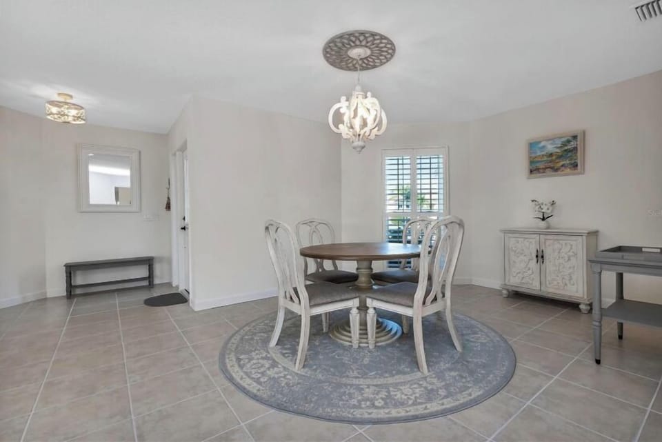DINING AREA IS LOCATED NEAR GAME ROOM WITH AMAZING VIEW TO CANAL/POOL