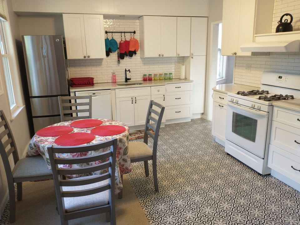 Kitchen with oven, stove, air fryer, dishwasher, new chairs. Tile and marble!
