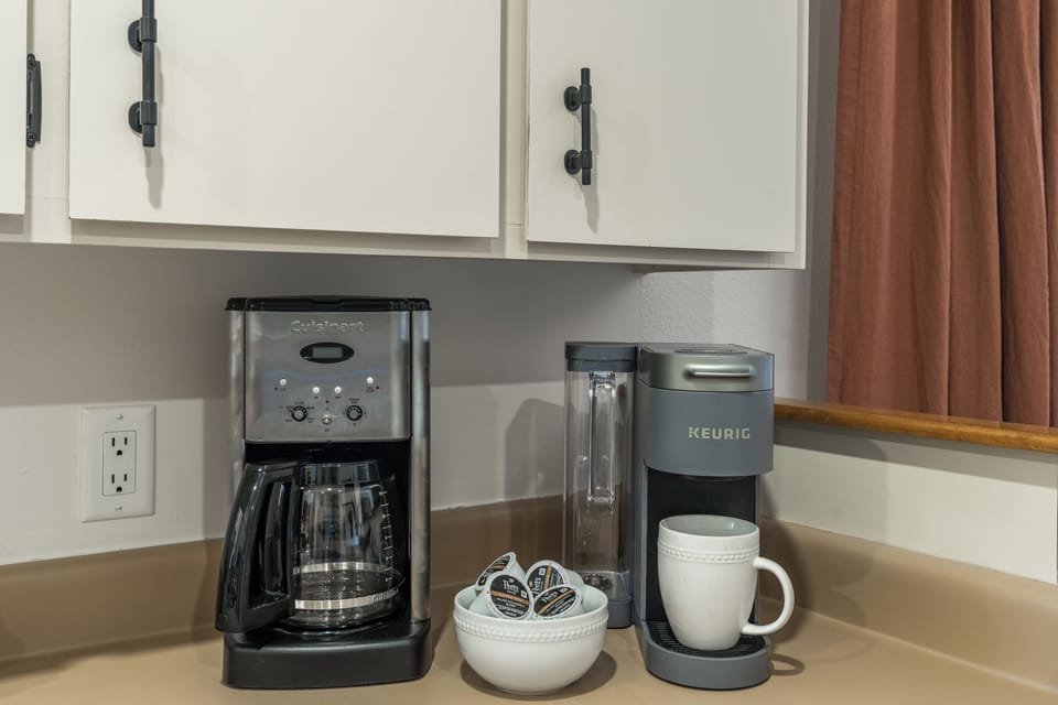 Fully equipped kitchen with stainless appliances, including both a standard coffee maker and a Keurig.