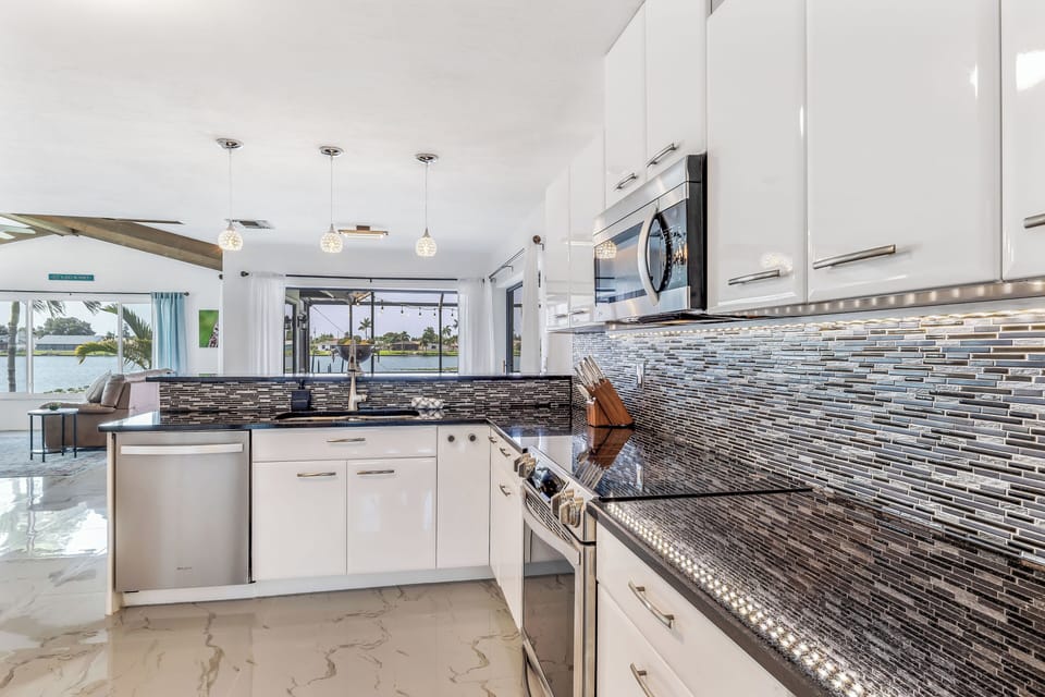 Kitchen with eat in bar that flows with the dining room.  Gorgeous lake views!