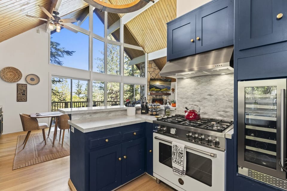 Gourmet kitchen w/ gas range, large island & vaulted ceilings opening to the dining area