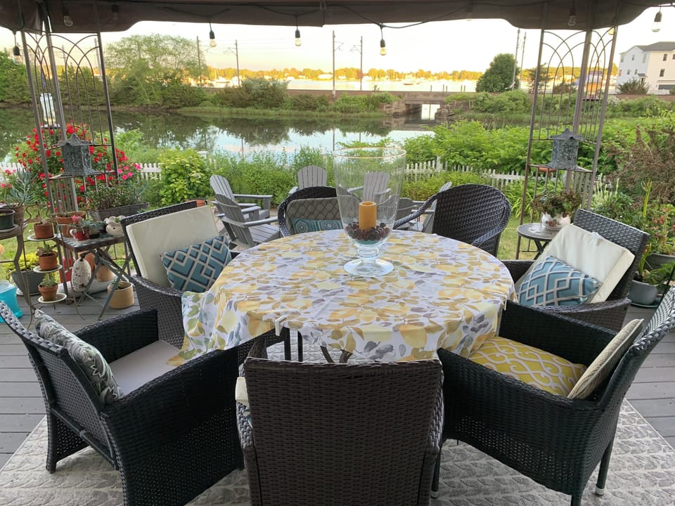 deck table and chairs beneath the gazebo