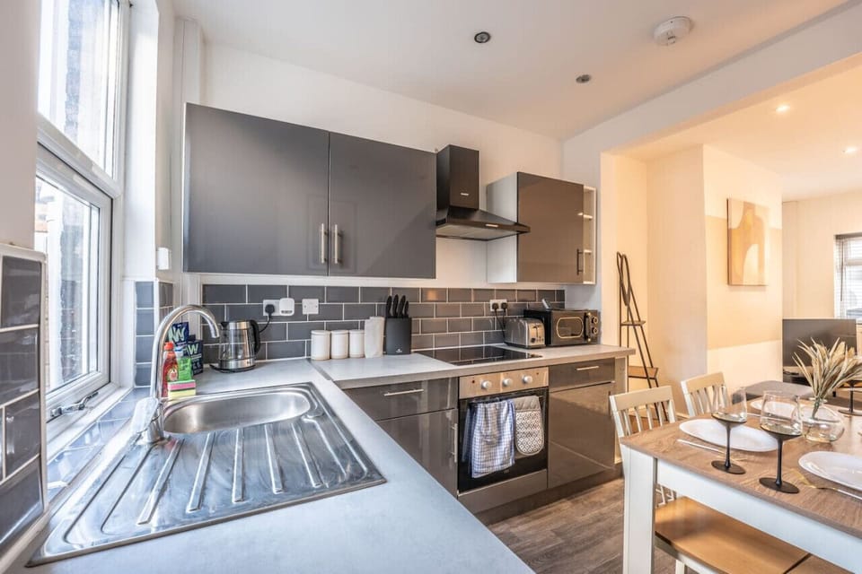 A modern, fully equipped kitchen complete with cookware, utensils and appliances — providing everything you need to create comfortable, home-cooked meals.