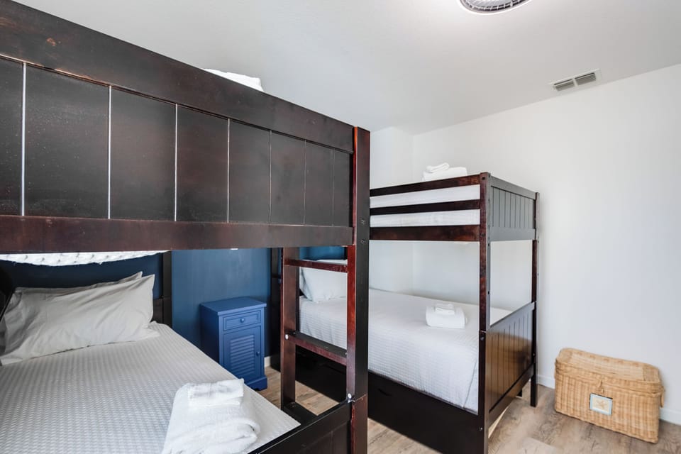 Sleep peacefully in this thoughtfully designed room featuring comfortable bunks and cozy bedding for your group stay.
