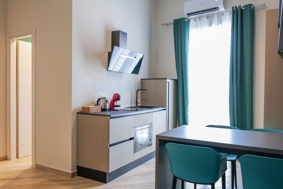 Family Suite, Balcony, City View | Private kitchen | Espresso maker, coffee/tea maker, electric kettle, coffee grinder