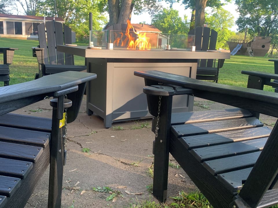 Just slide the wine or cup holders out on these Adirondack chairs and relax 