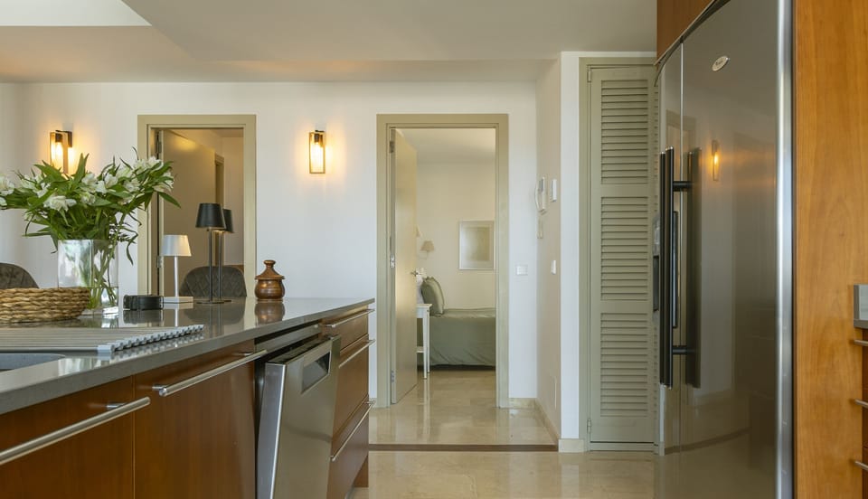 View from the kitchen towards the hallway leading to the bedrooms, featuring bright spaces and modern details.