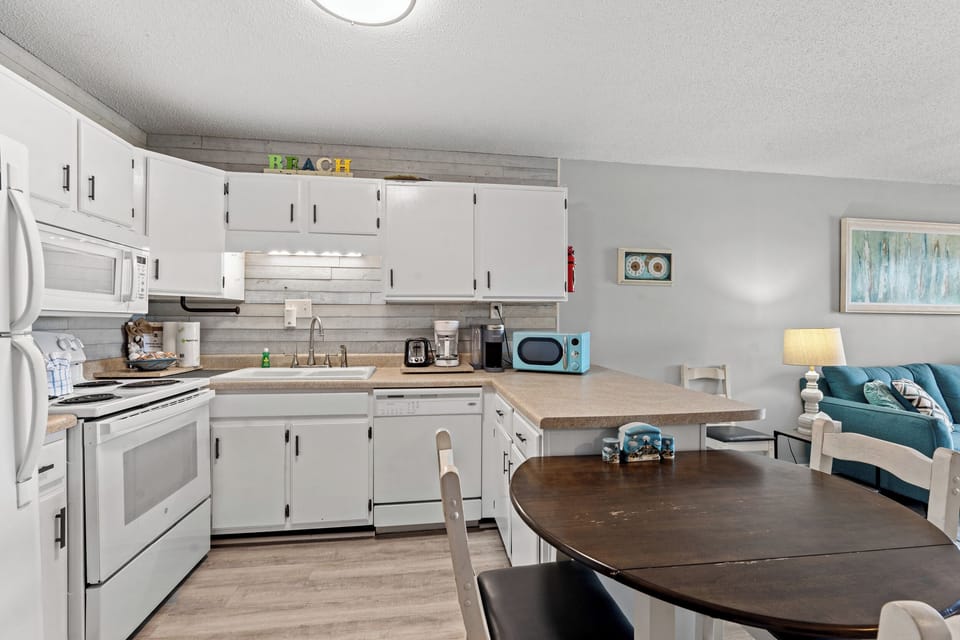 Full Kitchen with Microwave, toaster, coffee maker, cooking utensils, and more.