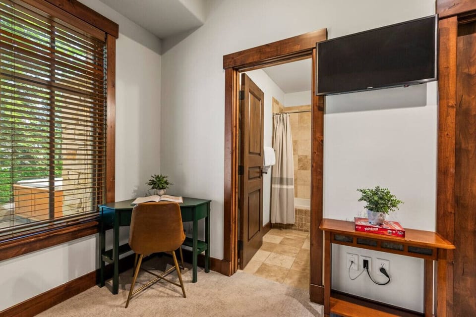 Small desk located in the bunk room with TV and walk in closets with board games included