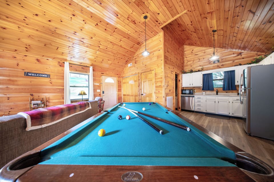 Blue-felt pool table, crackling fire, and cabin coziness—your perfect indoor escape.