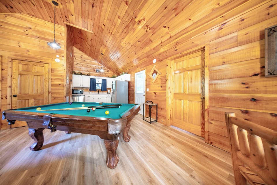 Play, dine, and unwind in this rustic retreat with billiards, stone hearth, and cozy charm.